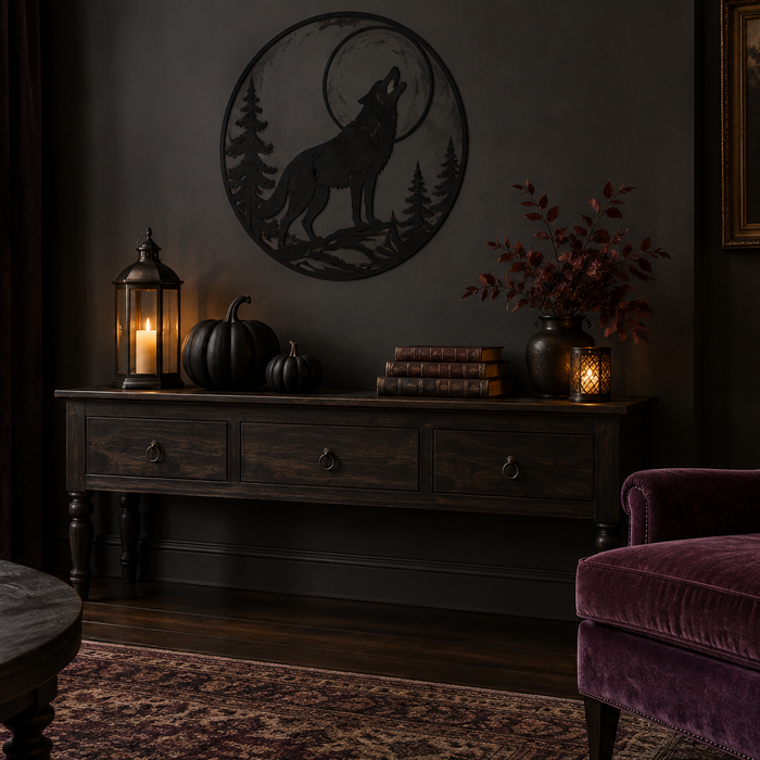 Gothic Halloween living room inspiration with wolf silhouette wall art, black pumpkins, warm lanterns, and a plum armchair.